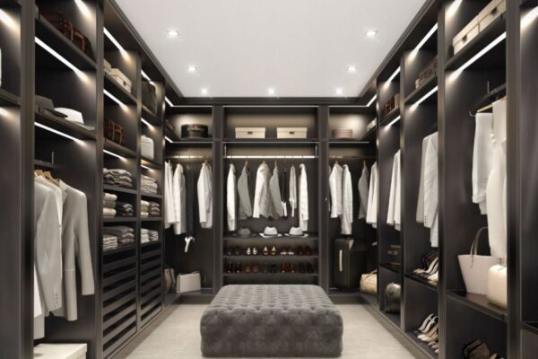 Stylish wardrobe with open doors and accessories, organized closet with hanging clothes and shelves, interior of a walk-in closet.