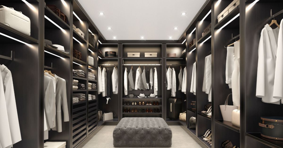 Stylish wardrobe with open doors and accessories, organized closet with hanging clothes and shelves, interior of a walk-in closet.